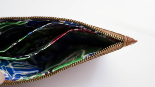 Leather wallet lined with silk, with three sections.