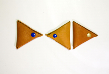 Simple triangle leather coin pouch with snap closure.